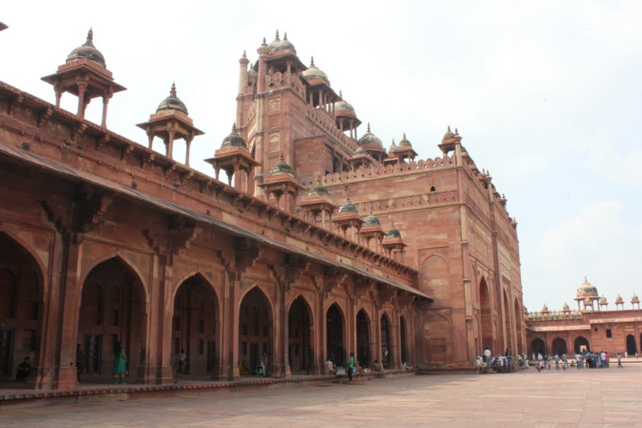 Rotes Fort (Agra): Die gesamte Fort-Anlage hat einen halbmondförmigen Grundriss und ist von einer bis zu 21 Meter hohen Mauer umgeben, deren Umfang 2,4 Kilometer beträgt. Die Mauer besteht in ihrem Kern, wie die Mehrzahl der umschlossenen Gebäude, aus Zie