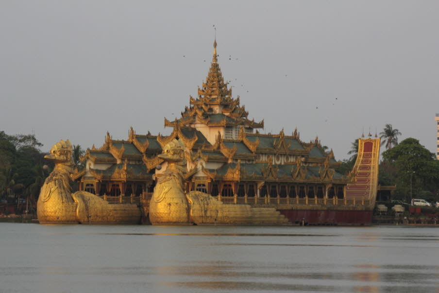 Blick auf das Karaweik Palace und sein mehrstufiges Pyatthat-Dach. Kandawgyu Lake in Yangon: Das Karaweik Palace wurde nach dem Vorbild des burmesischen Königsschiffs nach Plänen des Architekten U Ngwe Hlaing errichtet. Nach zwei Jahren Bauzeit wurde das 